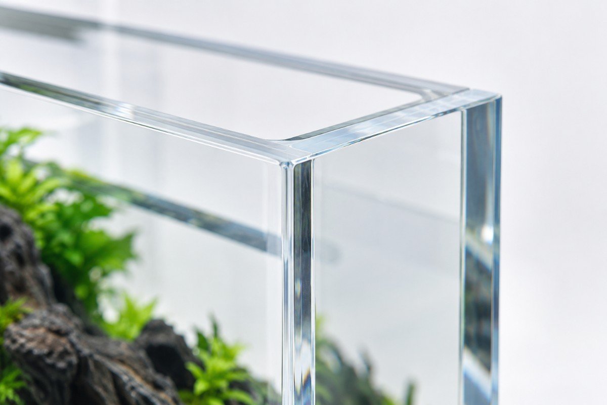 Seamless bonded corner on a cast acrylic aquarium panel, showing no visible join