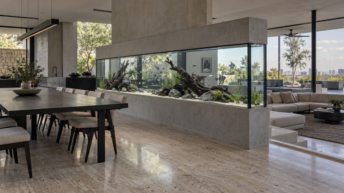 Custom aquarium built into a partition wall between hall and dining